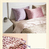 Close-up of stacked leopard print satin pillowcases showing precise lock edge thread control.
