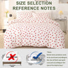 White duvet cover set with a red heart print and pillow cases displayed on a bed.