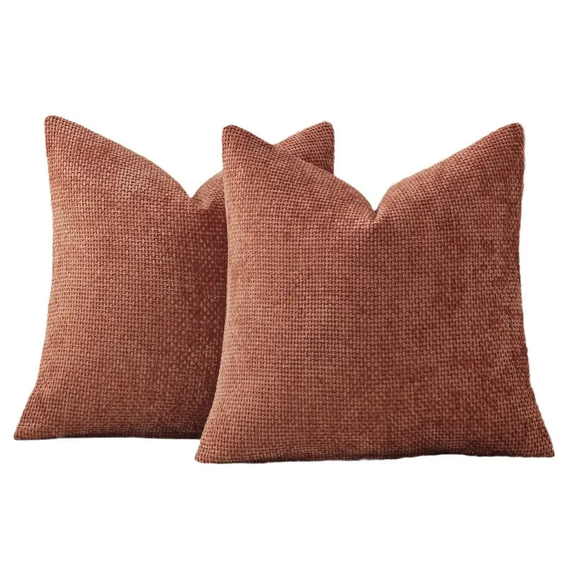A square, textured terracotta brown chenille pillow cover with a subtle ruffled edge.