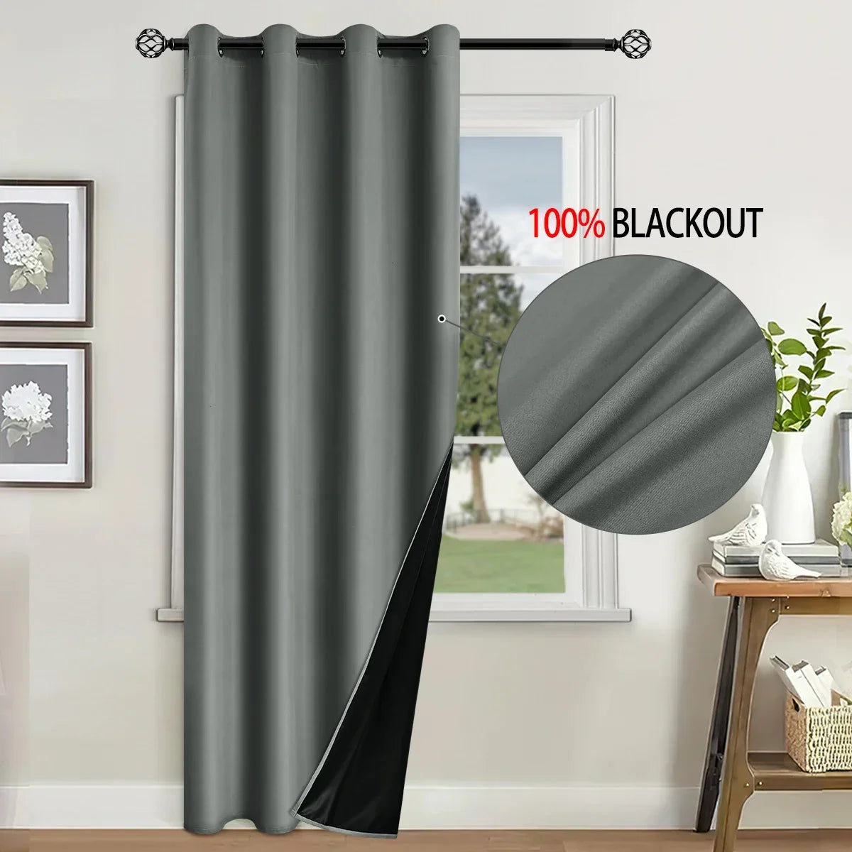 A gray blackout curtain hanging on a rod in a window frame.