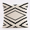 Geometric black and white throw pillow covers featuring a repeating diamond pattern
