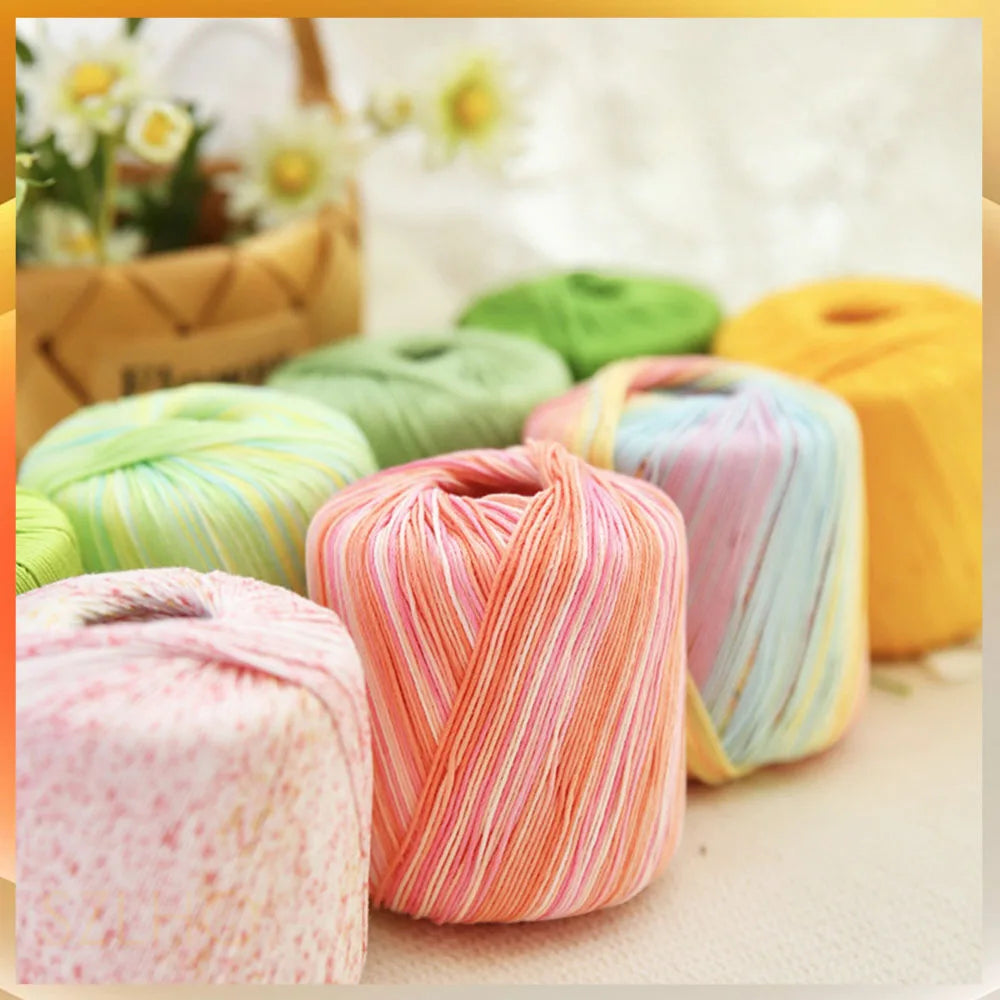 A collection of hand knitting yarn spools in various shades including pink, yellow, and green.