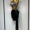 A mannequin displays a sparkly diamond two-piece performance set featuring embellished top and a black draped skirt.
