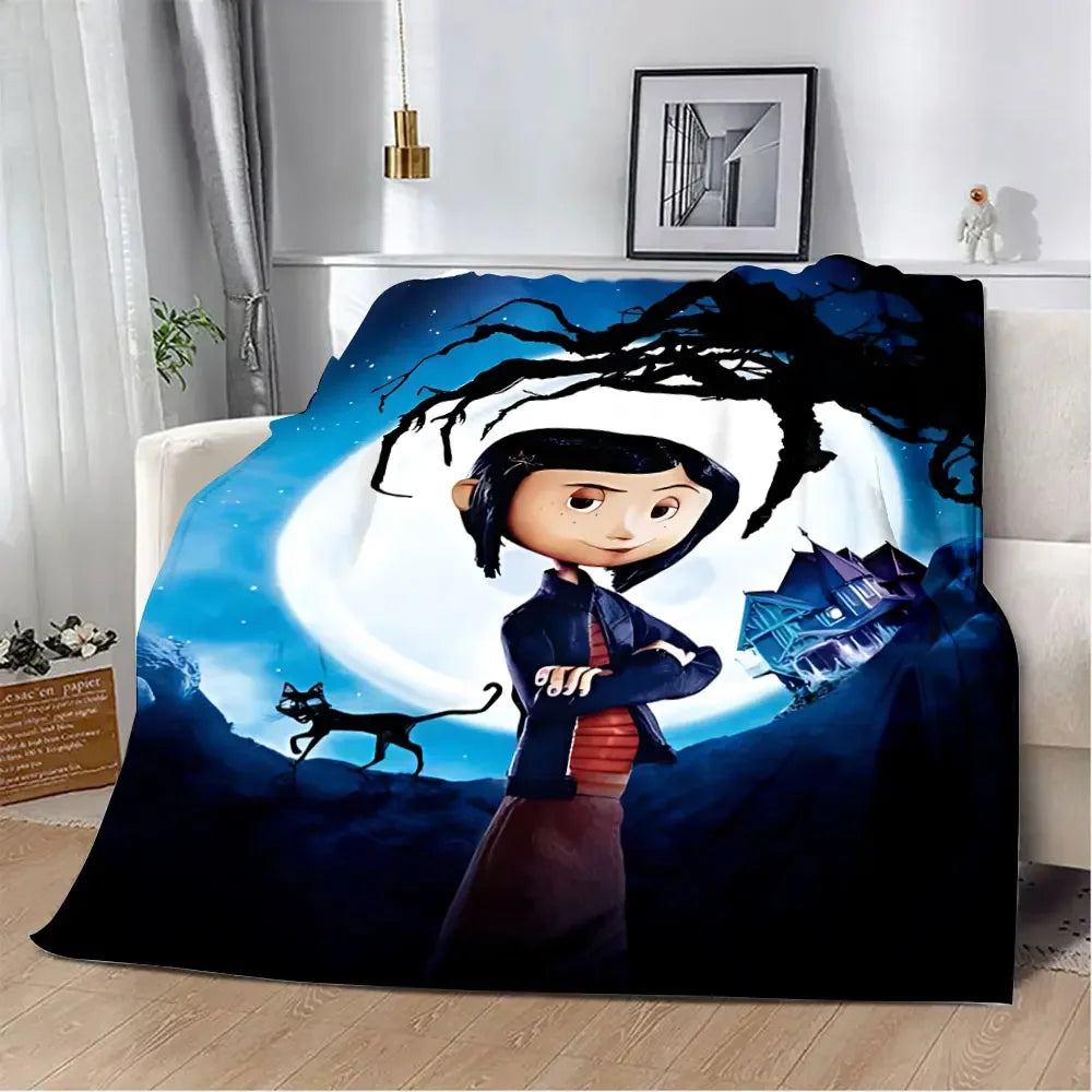 An animated print blanket featuring a character resembling Coraline standing beneath a large tree against a blue night sky.