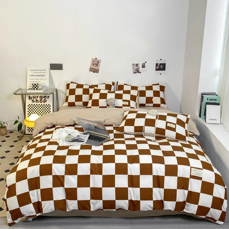 A brown and white checkered duvet cover set displayed on a bed with a white wall background.