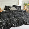 Black and white marble print duvet cover set with pillows on a bed