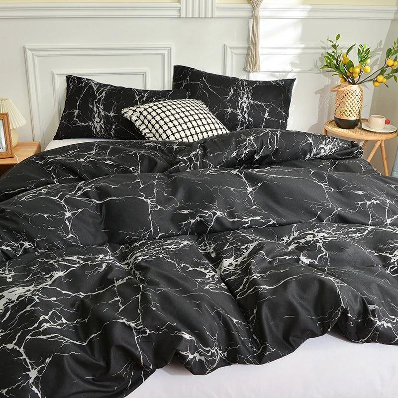 Black and white marble print duvet cover set with pillows on a bed