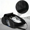 A black portable shoe carrier bag with a mesh insert is shown open on a gray surface.