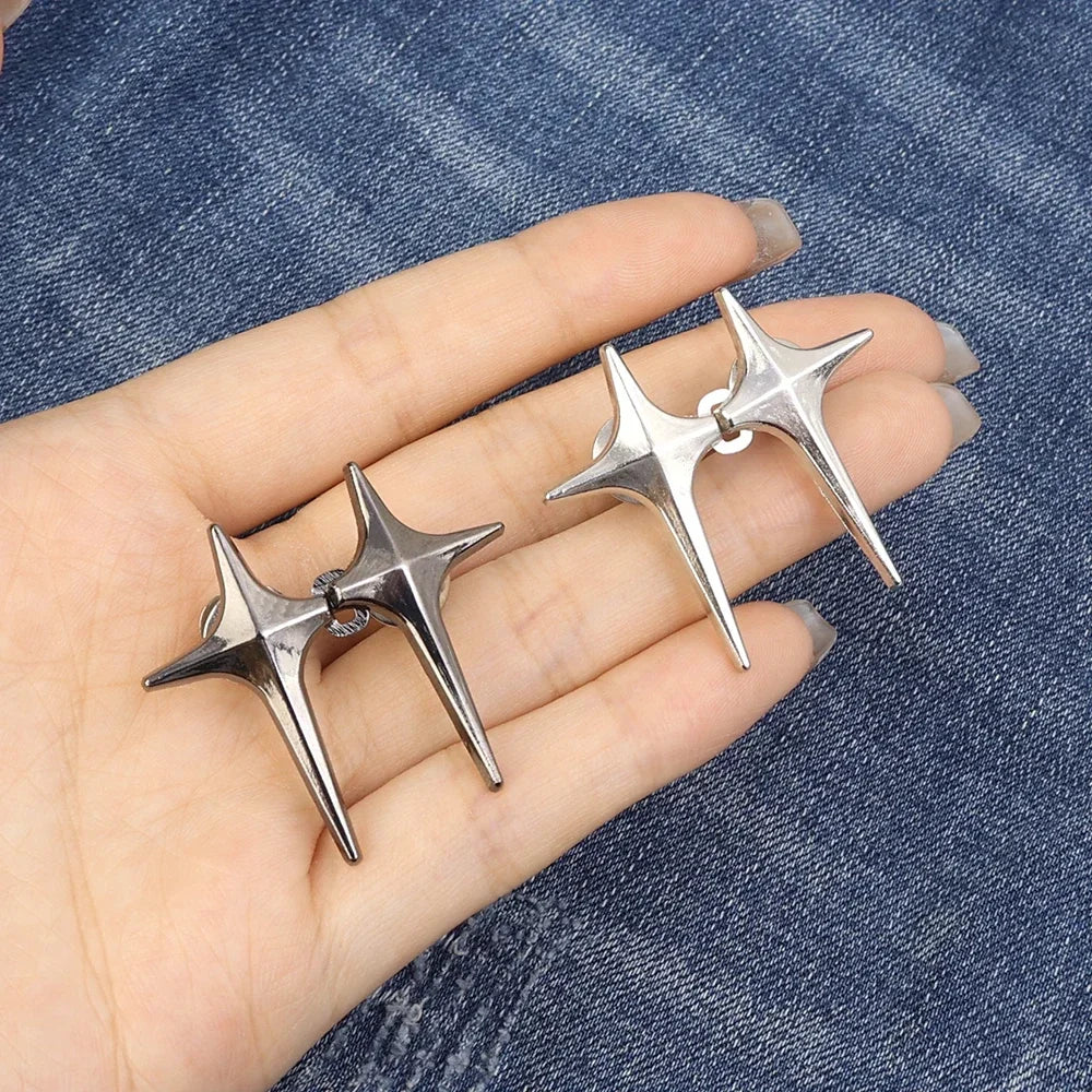 Silver Y2K star clips for jeans and skirts displayed on a hand against a denim background