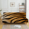 A brown and black zebra print velvet sofa cover displayed on a wooden frame with a light rug.