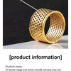 A gold-colored ring with a textured surface is shown against a dark background.