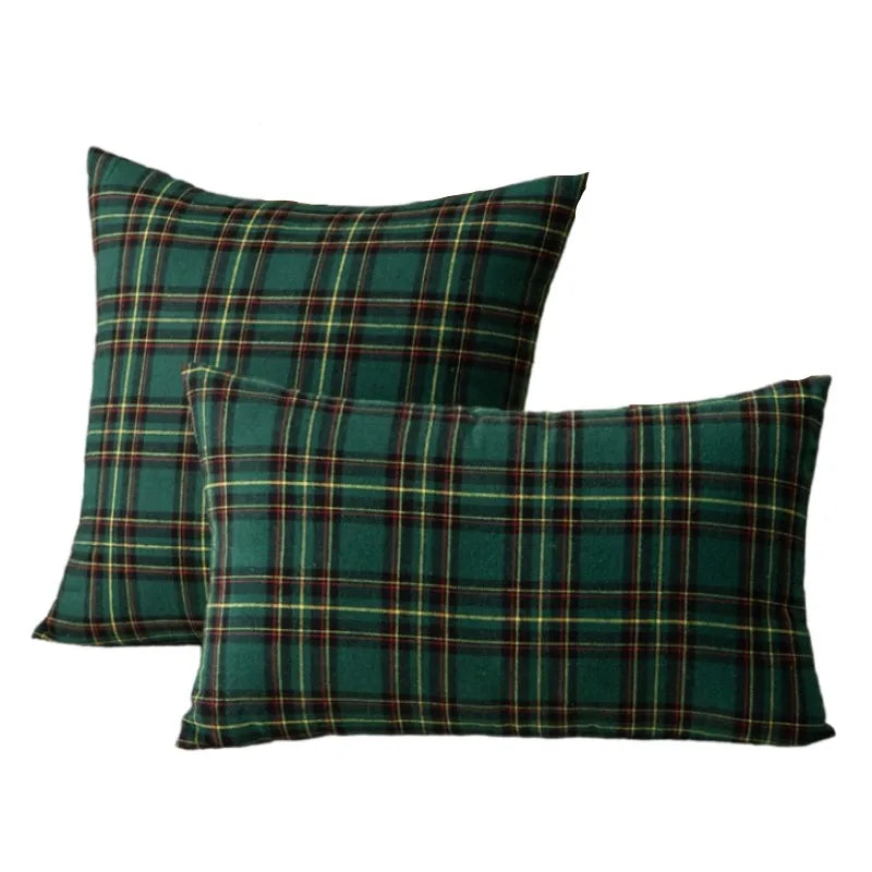 A set of two dark green and plaid tartan decorative throw pillow covers.