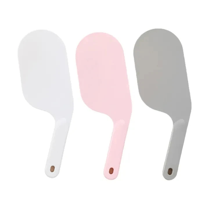 Three bed sheet folding and organizing tools in white, pink, and gray.