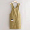 A khaki water-resistant kitchen apron hanging on a wooden hanger.