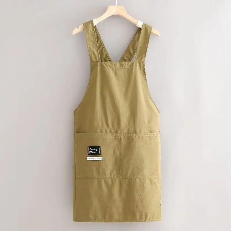 A khaki water-resistant kitchen apron hanging on a wooden hanger.