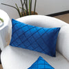 A deep blue quilted velvet decorative pillow on a white sofa with a matching pillow nearby.