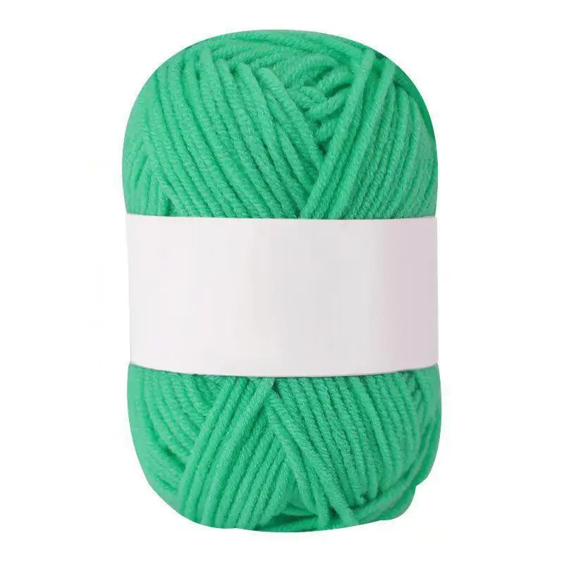 A ball of bright green soft milk cotton knitting yarn.
