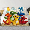 A throw blanket featuring colorful dinosaur cartoon characters and clouds on a light background.