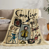 A beige flannel throw blanket featuring a black script name and various illustrated characters on a light background.