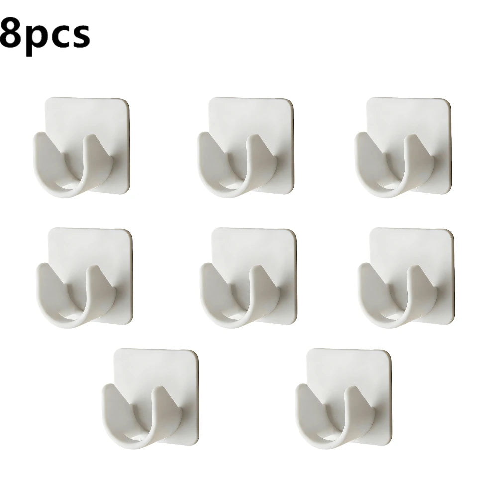 Eight self-adhesive curtain rod clips in a light gray color shown individually.