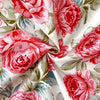Close-up of red and pink floral print fabric for flat bed sheets