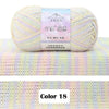 A ball of light pink and yellow gradient 4-ply cotton knit yarn for crafting projects.