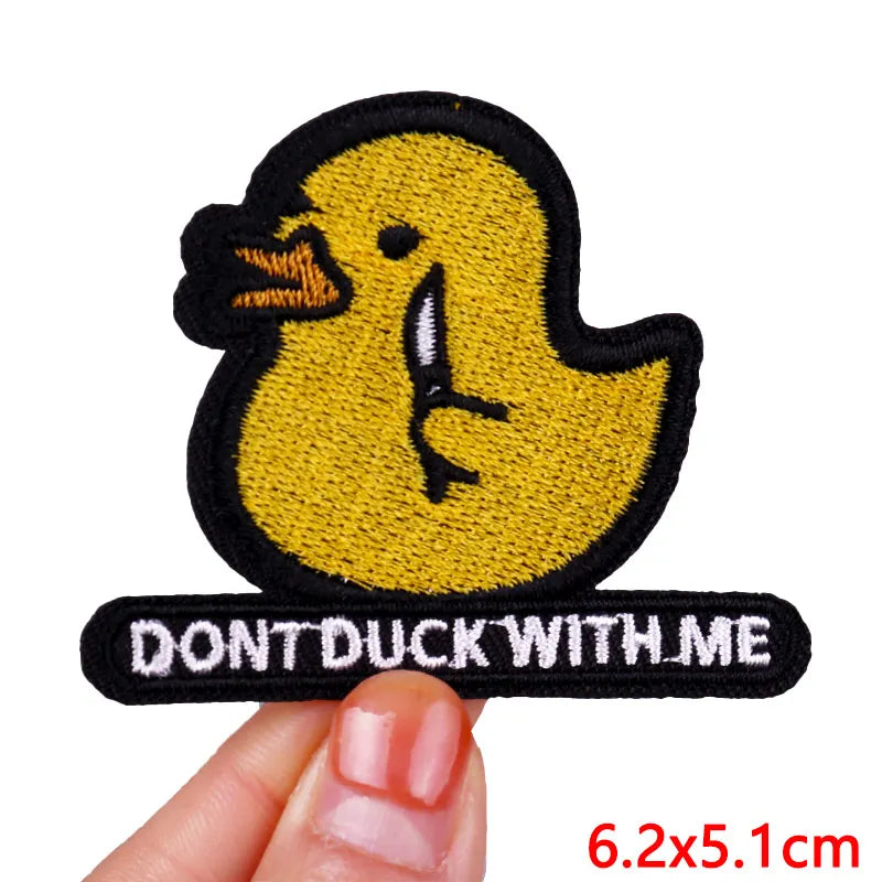 A yellow embroidered cartoon duck patch with black outline and the text DON'T DUCK WITH ME