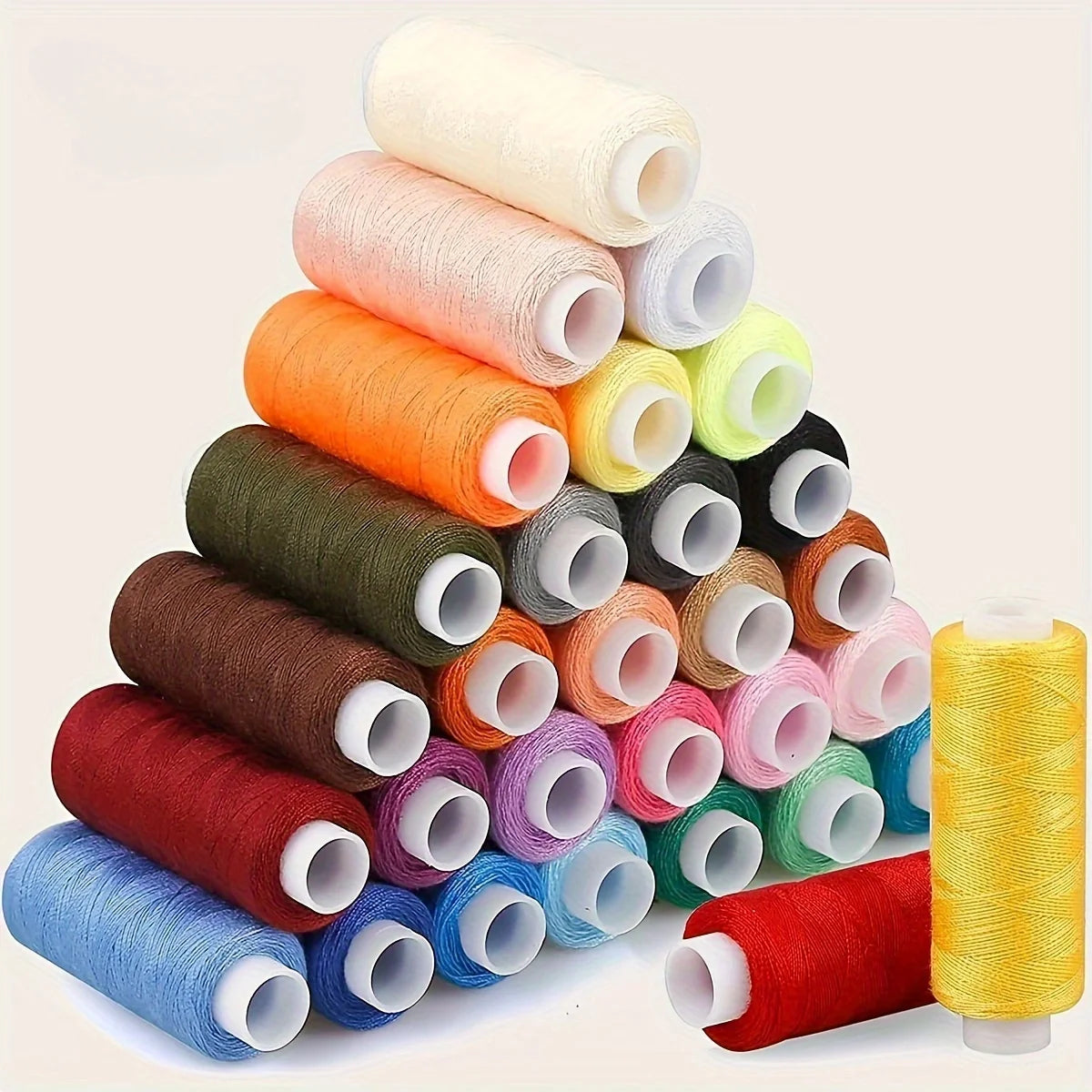 A stack of twelve rolls of mixed-color polyester sewing thread in various shades of orange, green, pink, and yellow.