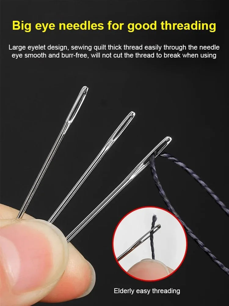 A hand holds several large eyelet needles for sewing, demonstrating easy threading.