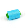 A spool of bright blue hand sewing thread with a green core.