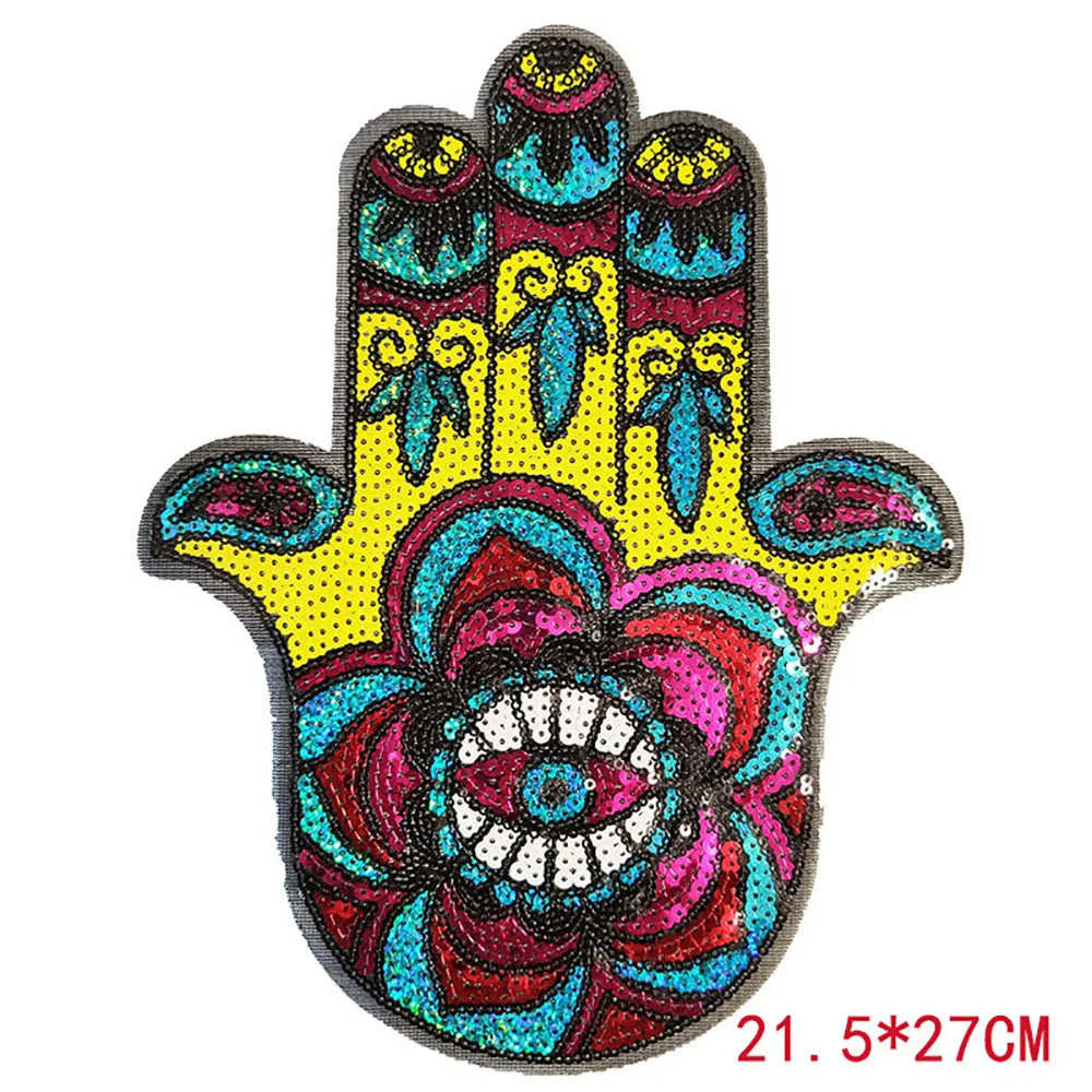A handprint iron-on patch made of multicolored sequins featuring a detailed floral design.