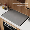 A multifunctional stove protection mat is shown on a kitchen counter, placed in front of a stove.
