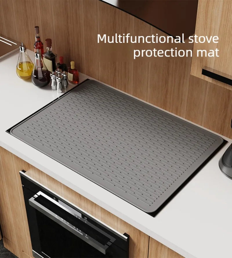 A multifunctional stove protection mat is shown on a kitchen counter, placed in front of a stove.