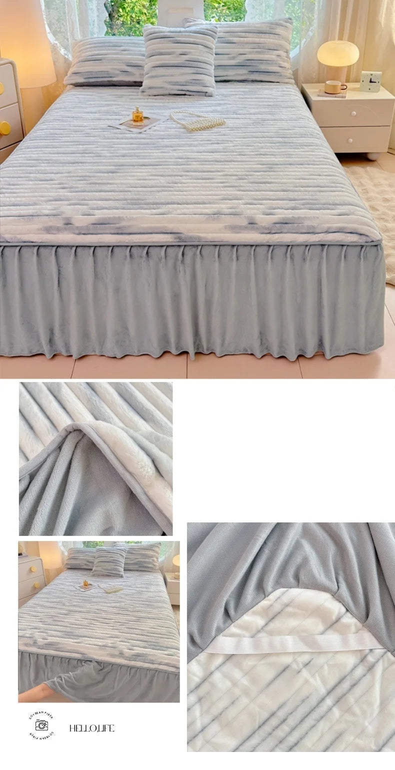 A gray plush bed skirt linen set featuring a textured fabric and matching pillows on a bed.