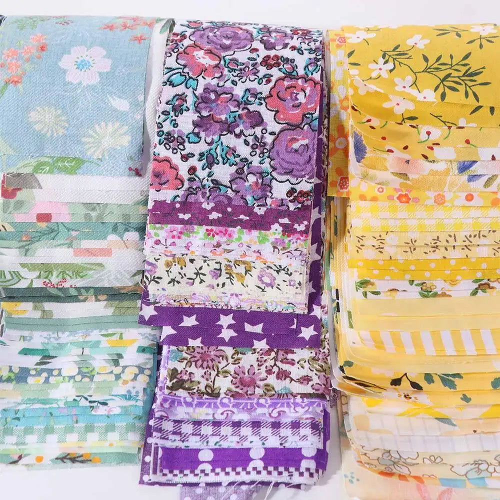 A collection of colorful floral cotton fabric strips in various patterns and colors for quilting and crafting