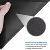 Close-up of a dark gray mouse pad showing the textured anti-slip rubber base