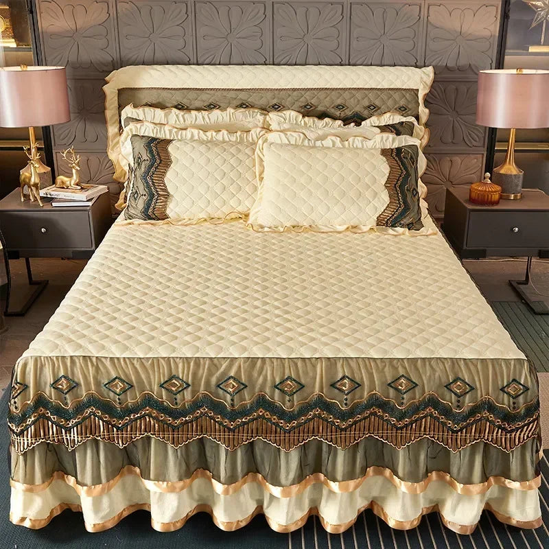 Elegant velvet bed skirt with gold trim and patterned fabric on a bed.