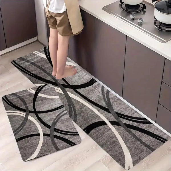 A long rectangular rug with a minimalist geometric pattern in shades of gray and black placed on a light wooden floor.