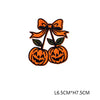 Orange pumpkin embroidery iron-on patch with a bow and green leaves