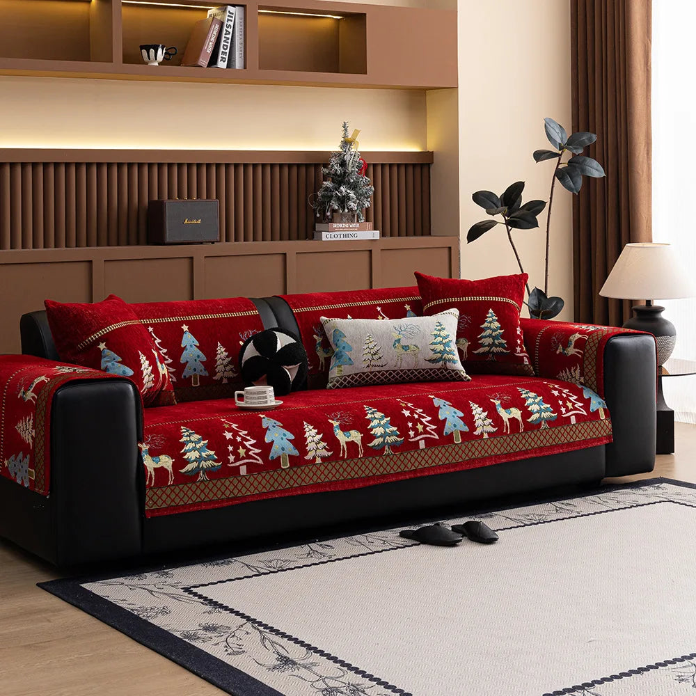 A deep red sofa mat cover featuring a Christmas deer pattern on a black sofa in a modern living room.