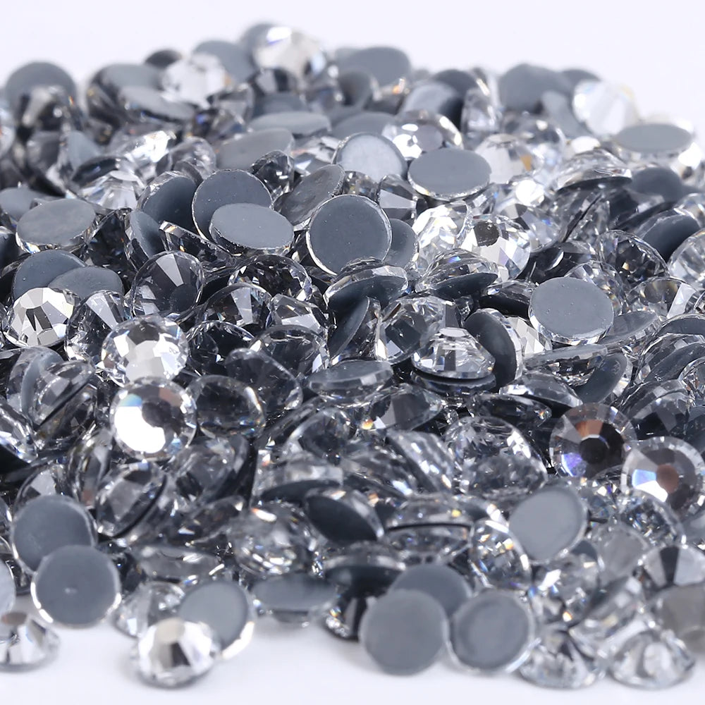 A pile of silver and black crystal AB flatback rhinestones for crafts and decor.