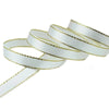 White satin ribbon with gold edges rolled into a coil