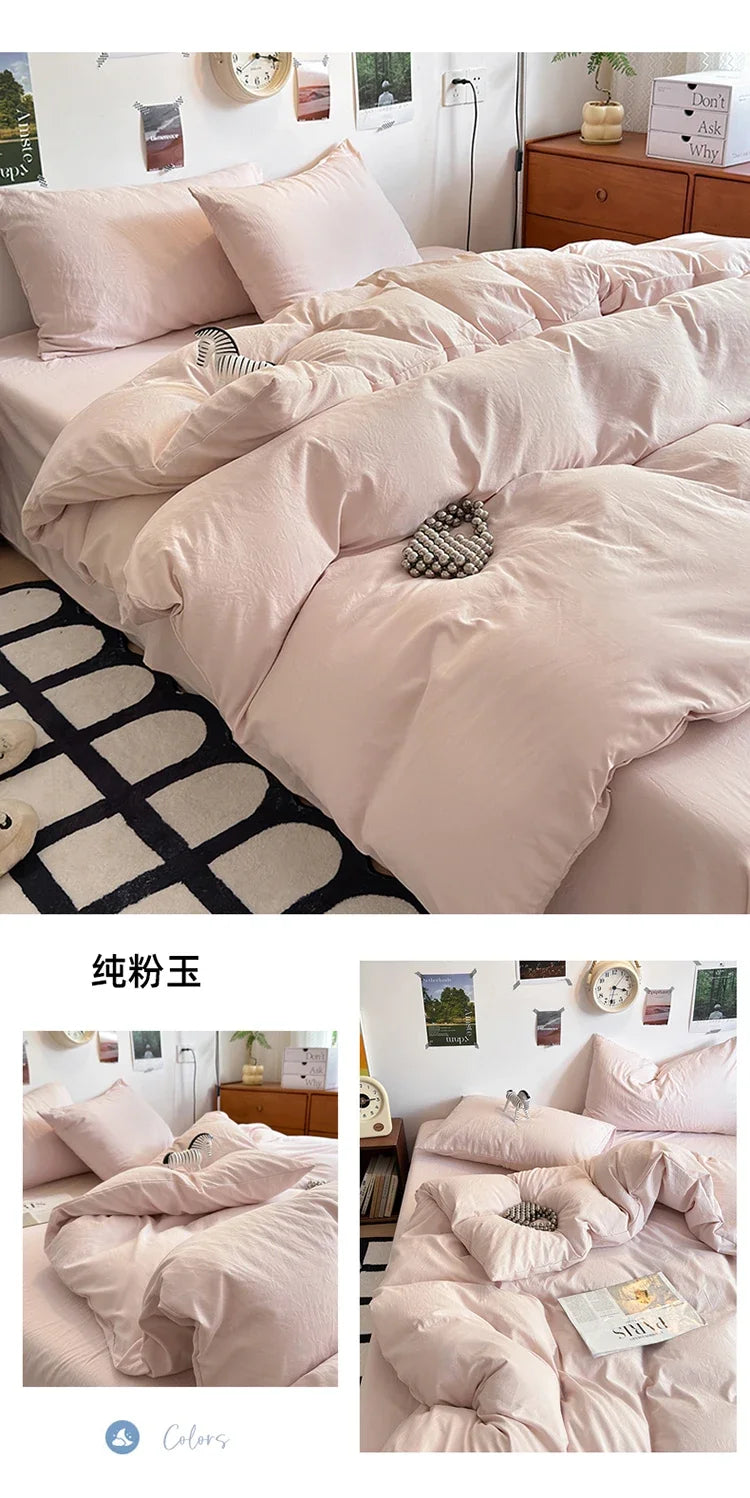 A set of ultra-soft washed cotton quilt bedding in a pale pink color displayed on a bed.