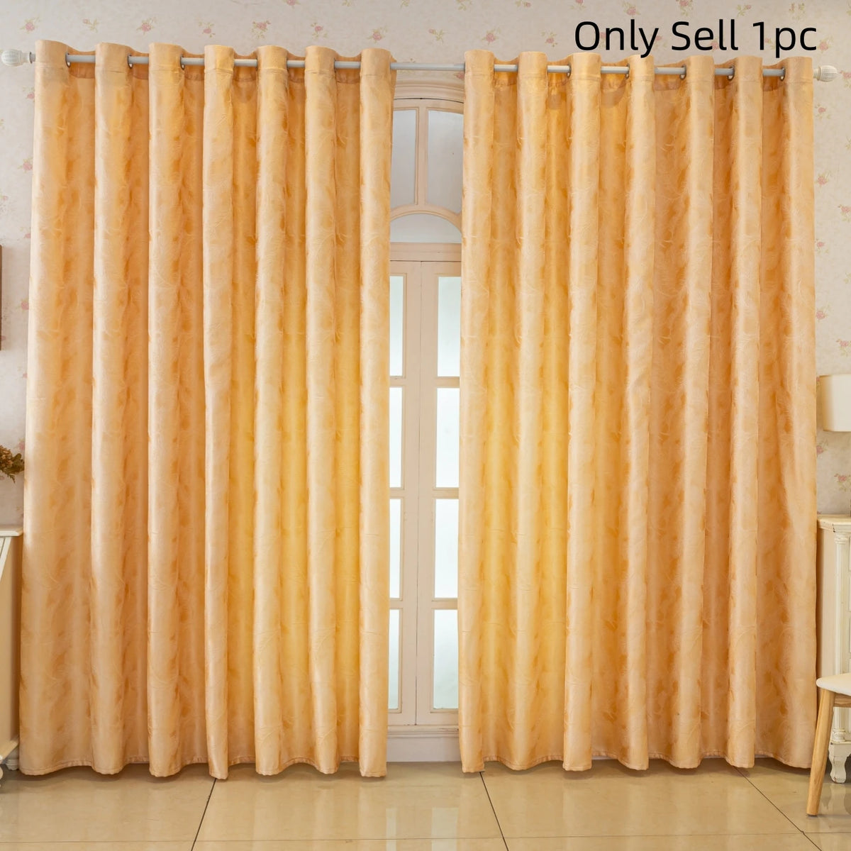 A pair of luxurious gold blackout curtains with a feather jacquard pattern hanging in a window.