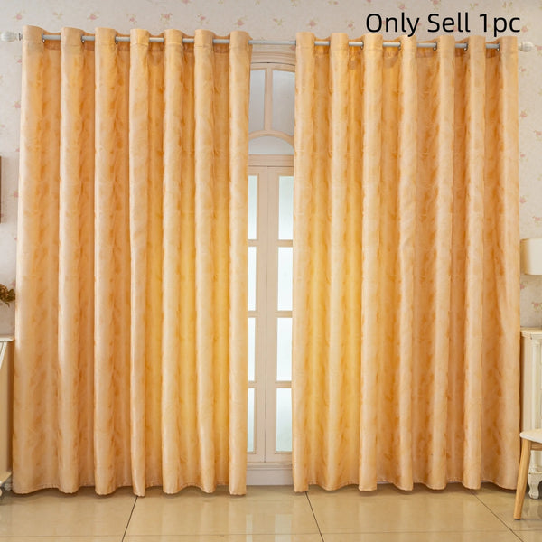 A pair of luxurious gold blackout curtains with a feather jacquard pattern hanging in a window.