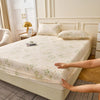 A floral fitted sheet set with pillowcases is displayed on a light-colored bed.