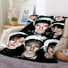 A fleece throw blanket featuring 3D printed images of Stray Kids members in various poses.