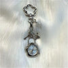 Silver pocket watch keychain featuring an adjustable clock mechanism attached to a decorative loop.