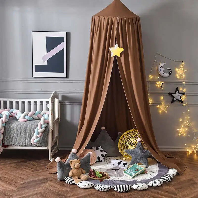 A princess hanging bed canopy with a brown fabric drape and a yellow star decoration set up in a room.
