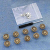 Silver metal button pins are displayed on a translucent white pouch against a blue fabric background.